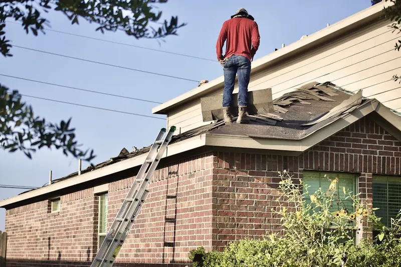 Professional roofer working on a residential roof in Redmond
